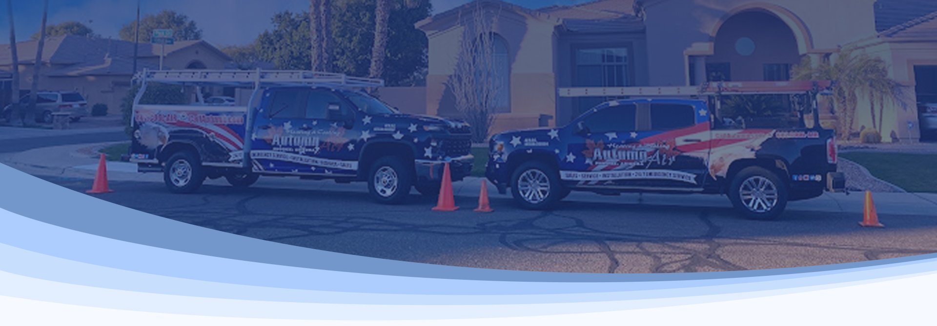 Two Autumn Air service trucks parked on a residential West Valley street.