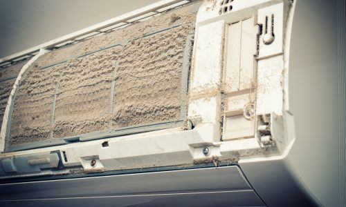 Closeup view of an open Air condition unit and very dirty air filters.